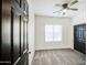 Cozy bedroom featuring a ceiling fan, plush carpeting, and a window for natural light at 5230 E Pony Track Ln, San Tan Valley, AZ 85140