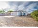 Charming single-story home with tile roof, two-car garage, and low maintenance front yard at 5230 E Pony Track Ln, San Tan Valley, AZ 85140
