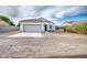 Charming single-story home with tile roof, two-car garage, and low maintenance front yard at 5230 E Pony Track Ln, San Tan Valley, AZ 85140