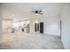 Open-concept living room flows into a kitchen with stainless steel appliances and an island at 5230 E Pony Track Ln, San Tan Valley, AZ 85140