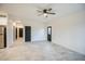 Bright living room featuring neutral walls, tile flooring, and modern ceiling fan at 5230 E Pony Track Ln, San Tan Valley, AZ 85140