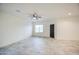 Bright living room featuring neutral walls, tile flooring, and modern ceiling fan at 5230 E Pony Track Ln, San Tan Valley, AZ 85140