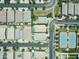 An aerial view showcases neighborhood homes, pools, streets, and a tennis court in the community at 5515 S Caisson Way, Mesa, AZ 85212