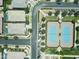 Aerial view showcases community tennis courts and lush green landscape of the surrounding neighborhood at 5515 S Caisson Way, Mesa, AZ 85212