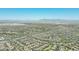 This aerial view shows a well-planned community nestled among the hills and desert, showcasing homes and streets at 5515 S Caisson Way, Mesa, AZ 85212