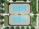 Overhead aerial view of community tennis courts with blue surfaces, surrounded by manicured landscaping and walking paths at 5515 S Caisson Way, Mesa, AZ 85212