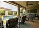 Relaxing covered patio featuring outdoor seating, a ceiling fan, and a serene pool view, perfect for leisure at 5515 S Caisson Way, Mesa, AZ 85212