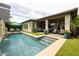 Inviting backyard featuring a sparkling pool, covered patio, and lush landscaping, perfect for outdoor living at 5515 S Caisson Way, Mesa, AZ 85212