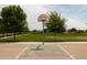 Community basketball court with a green court, red hoop, and treelined surroundings at 5515 S Caisson Way, Mesa, AZ 85212