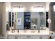 Modern bathroom featuring double sinks, sleek fixtures, and a spacious walk-in closet with ample storage at 5515 S Caisson Way, Mesa, AZ 85212