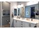 Bright bathroom with dual sinks, quartz counters, and a spacious walk-in closet, offering style and function at 5515 S Caisson Way, Mesa, AZ 85212