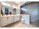 Elegant bathroom with double vanity, quartz countertops, and a glass-enclosed walk-in shower, offering modern luxury at 5515 S Caisson Way, Mesa, AZ 85212