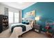 Stylishly designed bedroom featuring a tufted headboard and vibrant teal accent wall at 5515 S Caisson Way, Mesa, AZ 85212