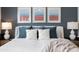 Comfortable bedroom featuring a queen bed with white coverlet and stylish accent pillows, plus tasteful wall decor at 5515 S Caisson Way, Mesa, AZ 85212