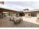 Outdoor community patio with neutral toned seating and pavers at 5515 S Caisson Way, Mesa, AZ 85212