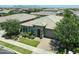 Aerial view of the home featuring stone accents, a lush lawn, and a paver driveway at 5515 S Caisson Way, Mesa, AZ 85212