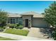 A detailed shot of the front of the house highlighting the stone details and manicured lawn at 5515 S Caisson Way, Mesa, AZ 85212