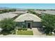 Beautiful single-story home featuring a stone facade, manicured lawn, and desert landscaping for enhanced curb appeal at 5515 S Caisson Way, Mesa, AZ 85212
