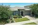 Attractive single-story home with a stone facade, manicured lawn, and colorful landscaping creating a warm and inviting entrance at 5515 S Caisson Way, Mesa, AZ 85212