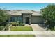 Charming single-story home with stone accents, a well-maintained lawn, and attractive landscaping for a welcoming appearance at 5515 S Caisson Way, Mesa, AZ 85212