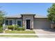 Charming home with stone accents, a modern front door, and well-maintained landscaping at 5515 S Caisson Way, Mesa, AZ 85212