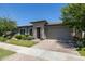Stylish home features stone accents, tidy landscaping, and a brick paver driveway at 5515 S Caisson Way, Mesa, AZ 85212