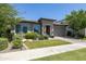 Attractive home featuring a stone facade, manicured lawn, and paver driveway at 5515 S Caisson Way, Mesa, AZ 85212