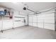 A clean, organized garage interior with finished walls, storage racks, and sealed floors at 5515 S Caisson Way, Mesa, AZ 85212