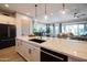 Modern kitchen with stainless steel appliances, spacious island, and easy flow into the dining and living spaces at 5515 S Caisson Way, Mesa, AZ 85212
