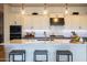 Stylish kitchen boasts white cabinets, marble countertops, and stainless steel appliances at 5515 S Caisson Way, Mesa, AZ 85212