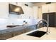 Modern kitchen showing detail of the gas range and black stainless fridge at 5515 S Caisson Way, Mesa, AZ 85212