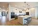 Modern kitchen with an island, pendant lights, and stainless steel appliances at 5515 S Caisson Way, Mesa, AZ 85212