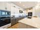 Modern kitchen with stainless steel appliances, gray cabinets, and a large island with a marble countertop at 5515 S Caisson Way, Mesa, AZ 85212