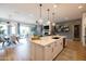 Open-concept kitchen with an island that looks into a dining and living room area, perfect for entertaining at 5515 S Caisson Way, Mesa, AZ 85212