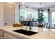 Bright and modern kitchen with marble countertops, stainless steel faucet, and view into the dining area at 5515 S Caisson Way, Mesa, AZ 85212