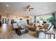 Bright open-concept space featuring a kitchen, living room, and dining area with comfortable seating and natural light at 5515 S Caisson Way, Mesa, AZ 85212