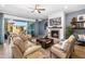 Bright living room with tile floors, fireplace, ceiling fan and view to the patio at 5515 S Caisson Way, Mesa, AZ 85212