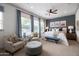 Serene main bedroom with a plush bed, stylish seating area, and ample natural light at 5515 S Caisson Way, Mesa, AZ 85212