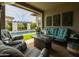 Comfortable covered patio featuring a cozy seating area with a fireplace, ideal for outdoor relaxation at 5515 S Caisson Way, Mesa, AZ 85212