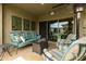 Relaxing outdoor area with a comfortable sofa, stylish decor, and a fire pit for cozy evenings at 5515 S Caisson Way, Mesa, AZ 85212