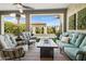 Covered outdoor patio featuring ample seating, ceiling fan, and pool views at 5515 S Caisson Way, Mesa, AZ 85212