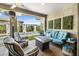 Covered patio with stylish seating area overlooking sparkling pool and lush landscaping at 5515 S Caisson Way, Mesa, AZ 85212