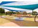 Community playground with climbing structure covered with a colorful shade structure at 5515 S Caisson Way, Mesa, AZ 85212
