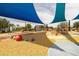 Community playground featuring colorful shade canopies and ground cover at 5515 S Caisson Way, Mesa, AZ 85212