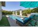 Beautiful pool featuring a pergola, small waterfalls, and an outdoor grill area at 5515 S Caisson Way, Mesa, AZ 85212