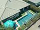 Overhead view of a swimming pool, sun umbrella, and lounge chairs near a covered patio at 5515 S Caisson Way, Mesa, AZ 85212