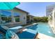 Backyard pool view showcasing lush landscaping, a water feature, and outdoor living space at 5515 S Caisson Way, Mesa, AZ 85212