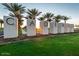 Cadence community welcome sign with sunset and palm tree backdrop on manicured lawn at 5515 S Caisson Way, Mesa, AZ 85212