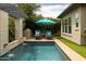 Beautiful pool with a stone wall waterfall feature and built-in outdoor grill area, perfect for outdoor entertaining at 5515 S Caisson Way, Mesa, AZ 85212