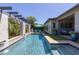 Stunning swimming pool with water feature, outdoor kitchen, and lounge area at 5515 S Caisson Way, Mesa, AZ 85212